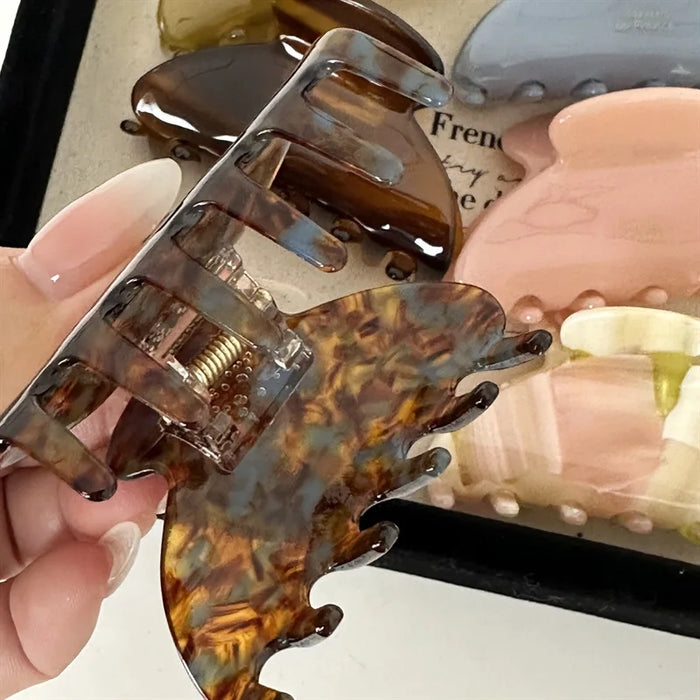 brown claw being opened while other claws are in the background with different colours